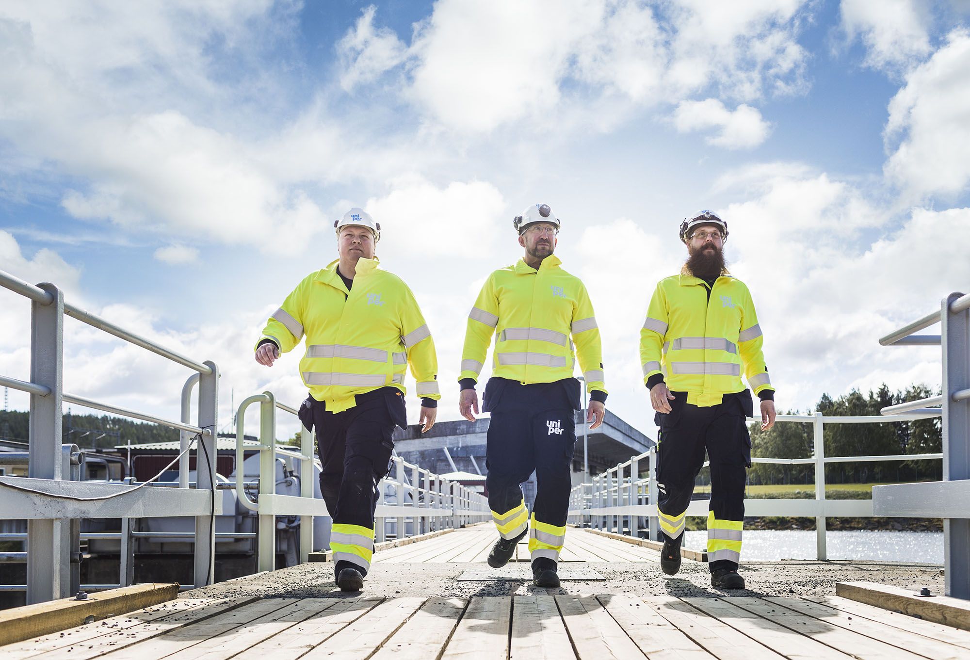 Uniper engineers walking across a bridge