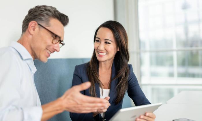 Employees in conversation with a tablet