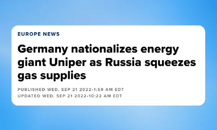 Alt text for this image could be:  "The Uniper logo displayed on a sign outside a modern building, with a combination of glass and dark metal elements.