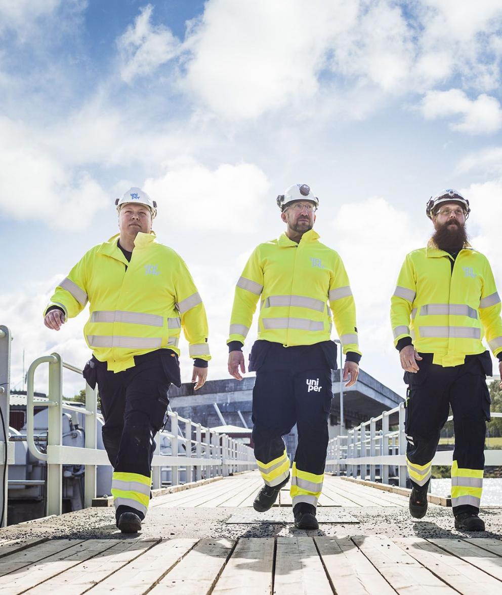 Uniper engineers walking across a bridge