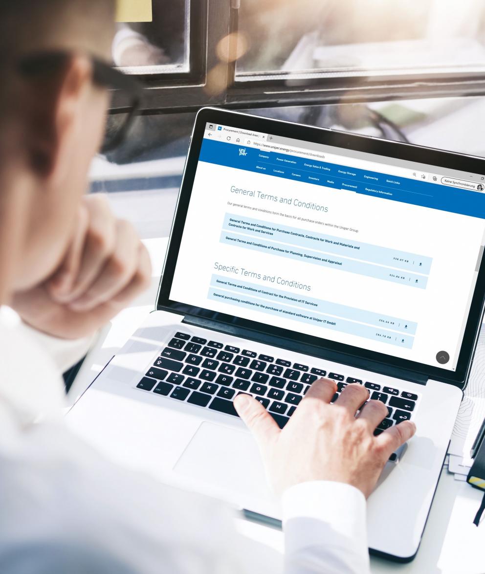 Customer at his laptop downloading the latest supplier documents