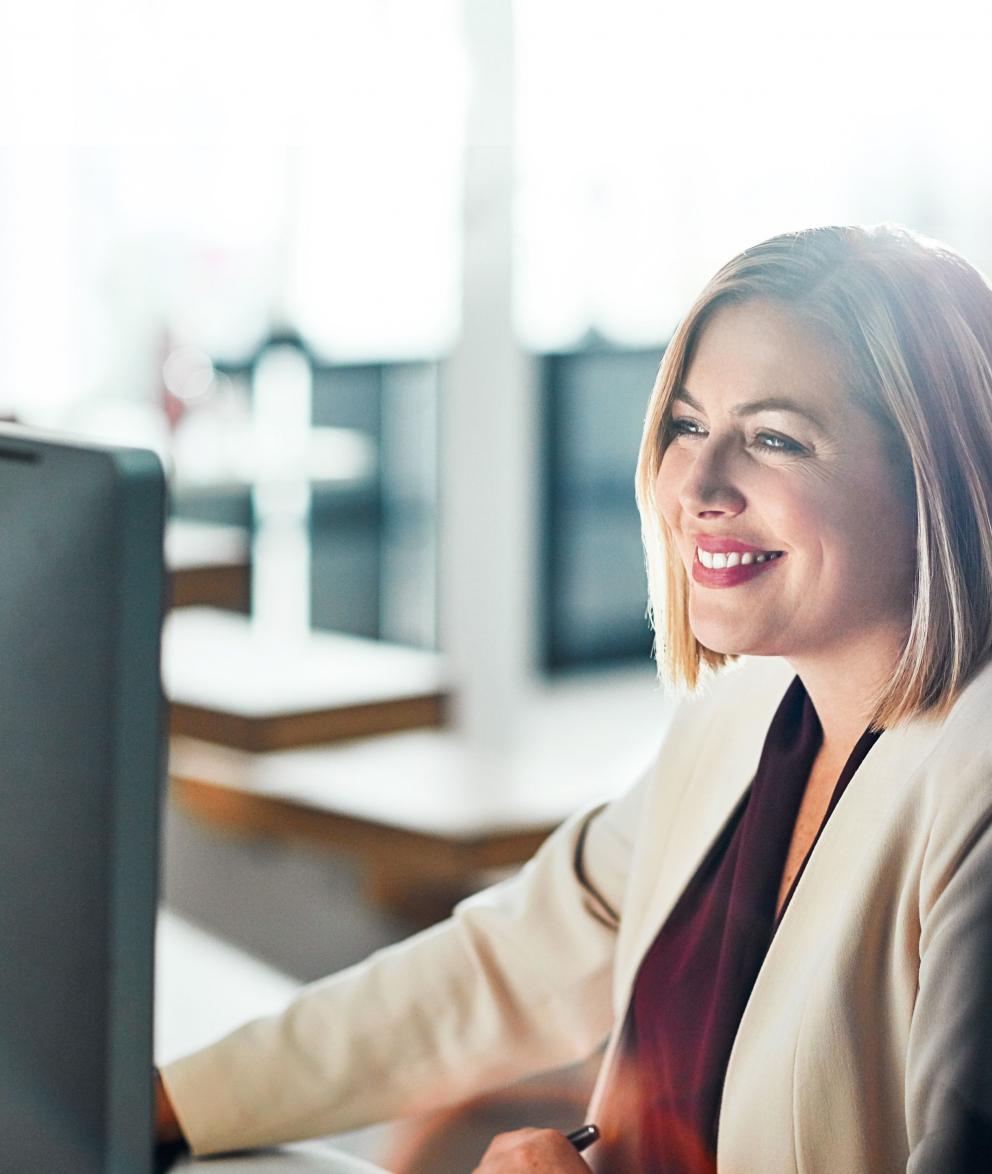 Close up of Uniper employee employee smiling at her desk