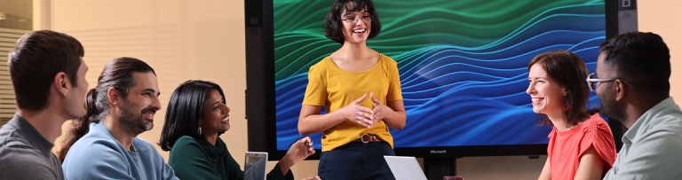 Uniper employees  in a meeting with an employee presenting infront of a digital screen