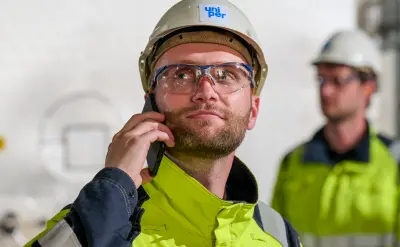 Proud person in work uniform with helmet
