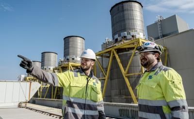 Workers next to Killingholme power plant stacks
