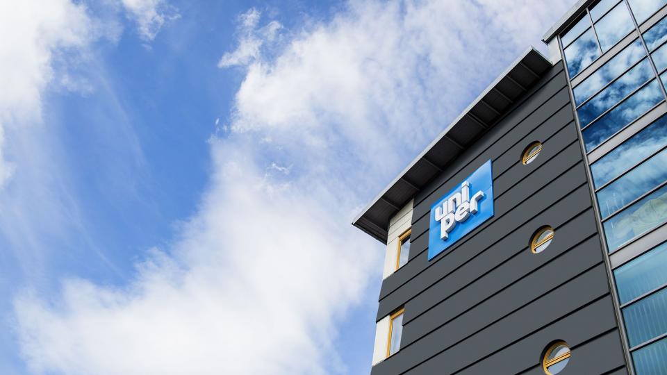 Exterior shot, looking up at the Uniper signage outside a hydro plant