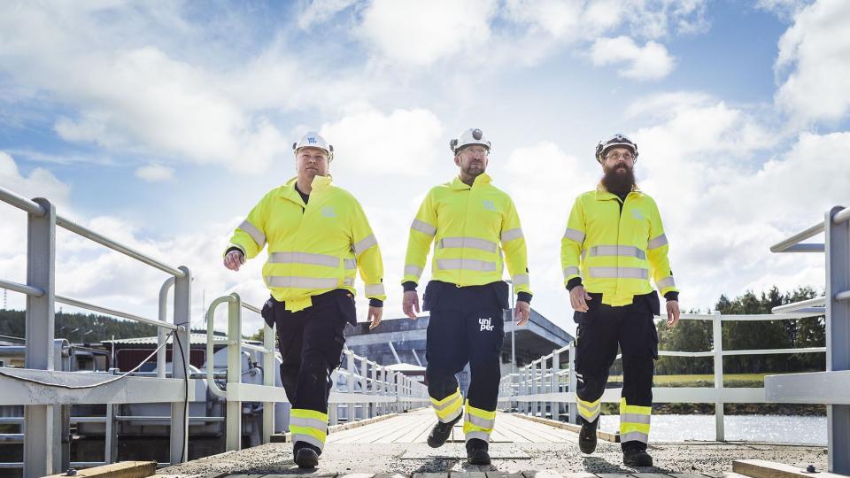 Uniper engineers walking across a bridge