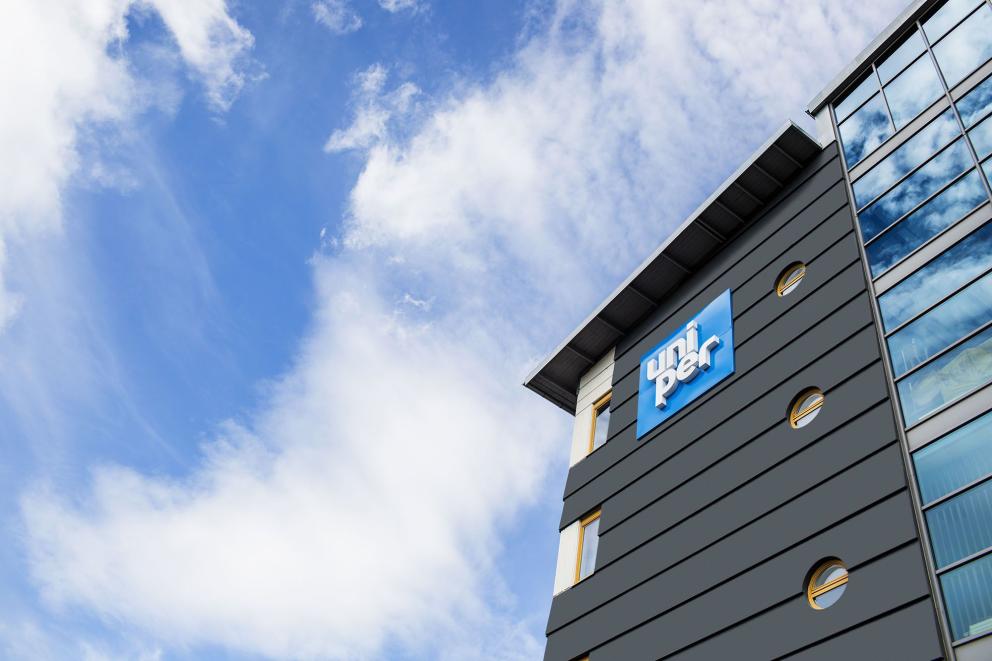 Exterior shot, looking up at the Uniper signage outside a hydro plant