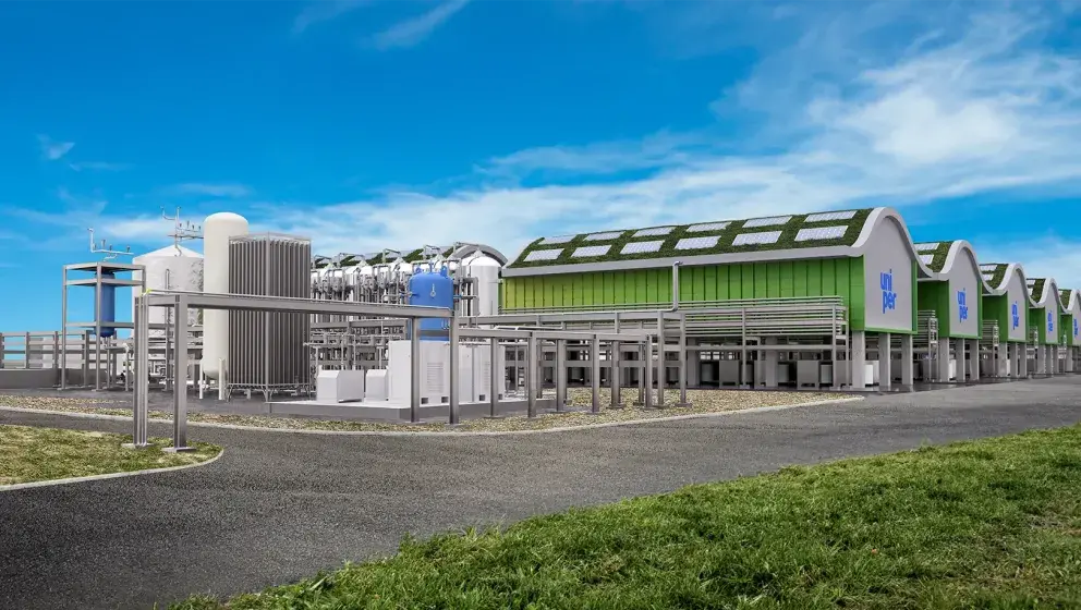 Rendering of a Uniper facility featuring industrial structures, green roofs with solar panels, and equipment used for hydrogen production, under a clear blue sky.