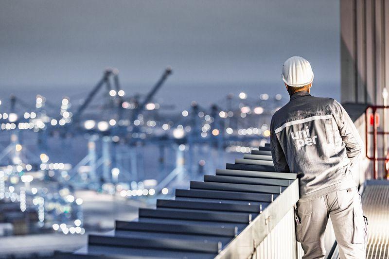 Maasvlakte in the dark with employee looking into the distance