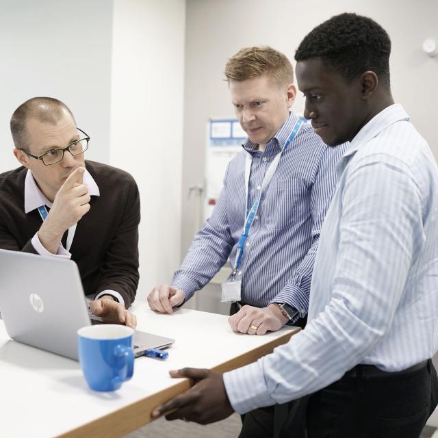 Employees in discussion at the Birmingham office