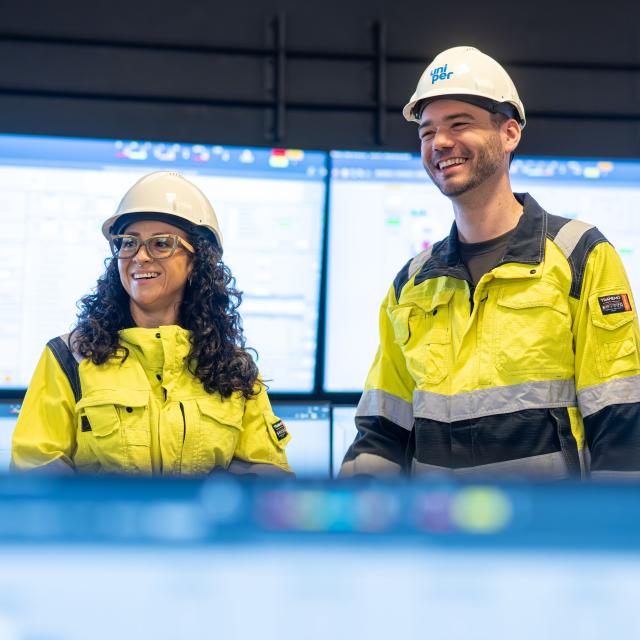 2 colleagues in high vis in a control room